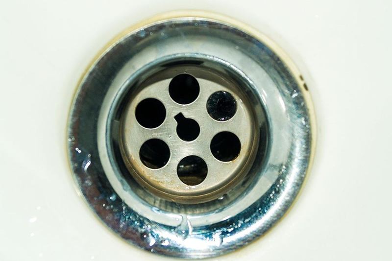 Close-up of a sink drain, when the drain smells bad