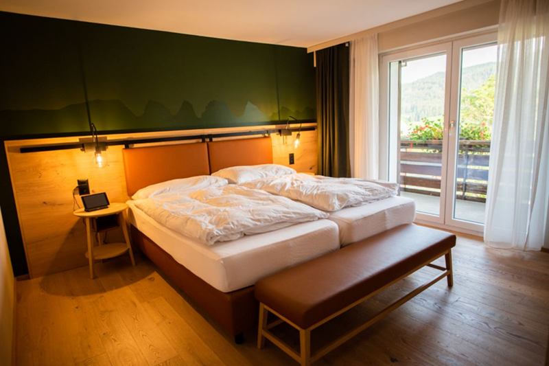 Bedroom with rumpled white bed linen, time to wash the sheets