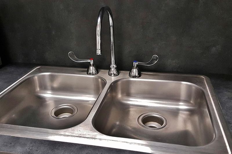 Shiny double stainless steel kitchen sink with tap