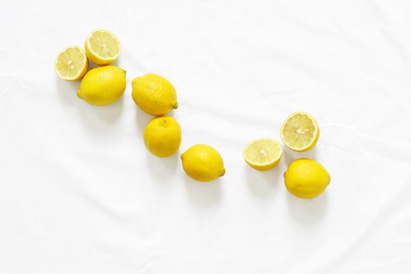 Fresh lemons on a white cloth, a home remedy for removing stains