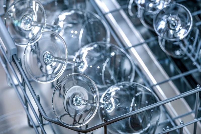 Wine glasses in the rack of a clean dishwasher