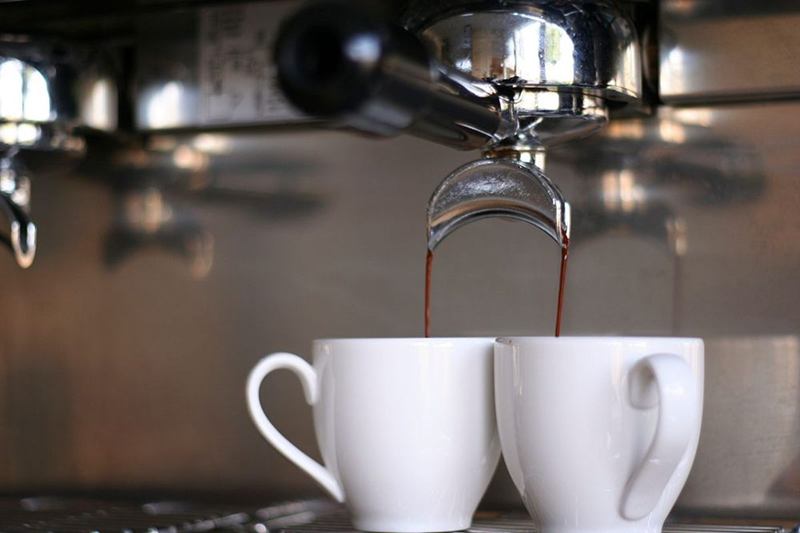 Espresso machine filling two white cups, a coffee machine worth descaling