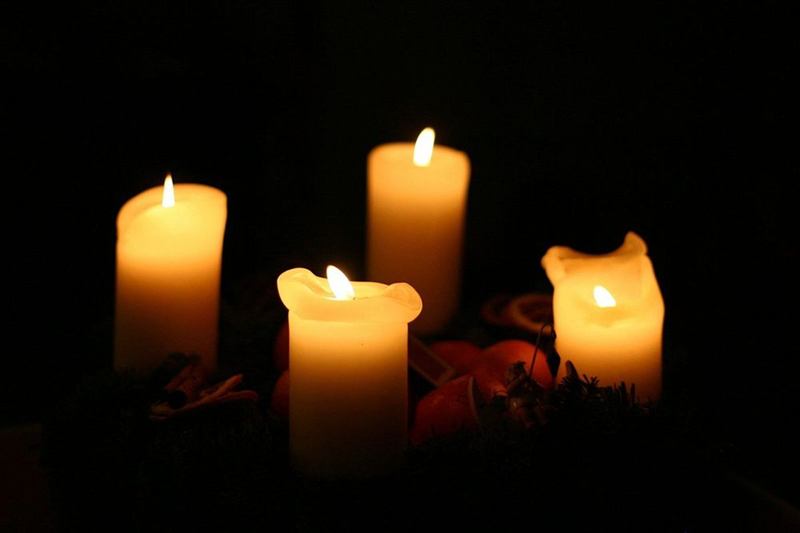 Burning candles with dripping candle wax in the dark