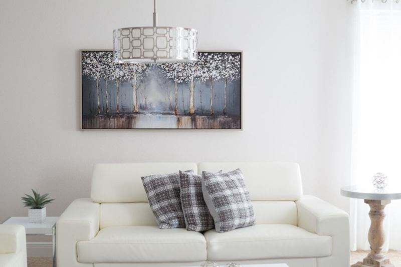 Bright living room with a white wall and painting, free of nicotine
