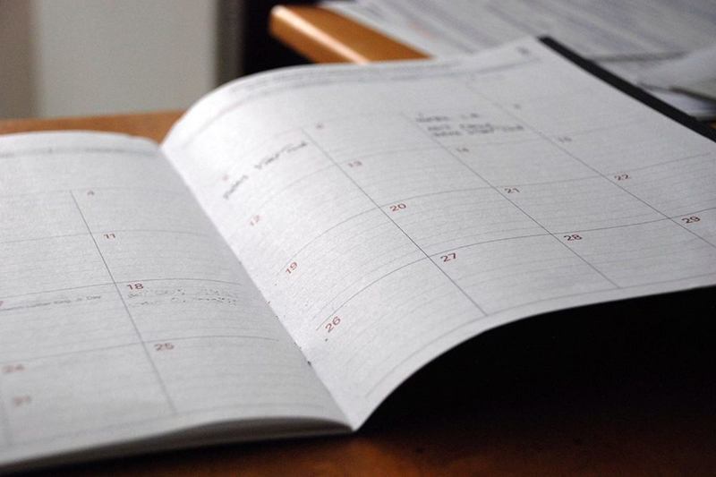 Open planner with notes for creating a cleaning schedule