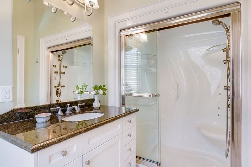 Shower cubicle with glass door and silicone seals beside the vanity