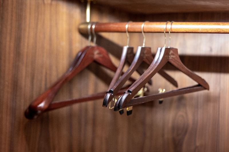 Wooden hangers in a wardrobe, avoiding mould behind furniture