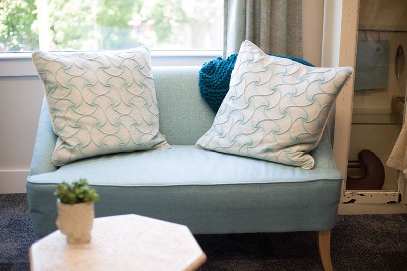 Light blue fabric sofa with cushions, ready for sofa cleaning