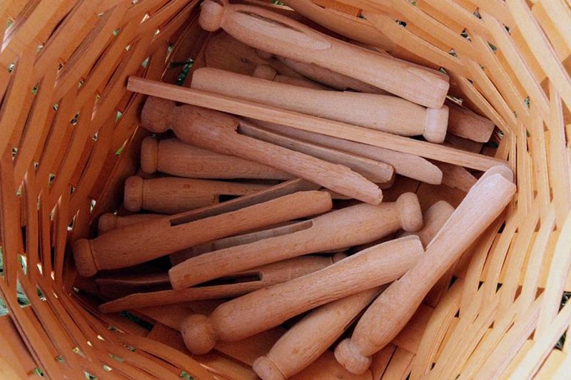 Wooden clothespins in a basket so laundry doesn't smell musty