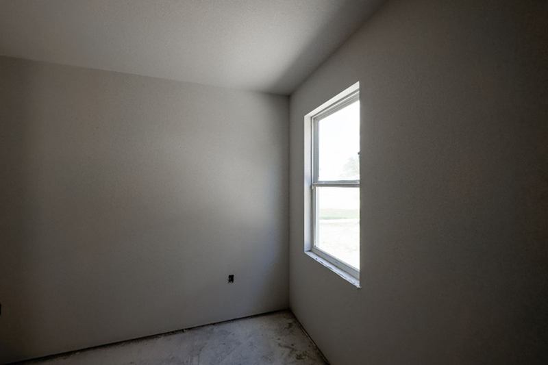 Empty room with a window on the last day before apartment handover